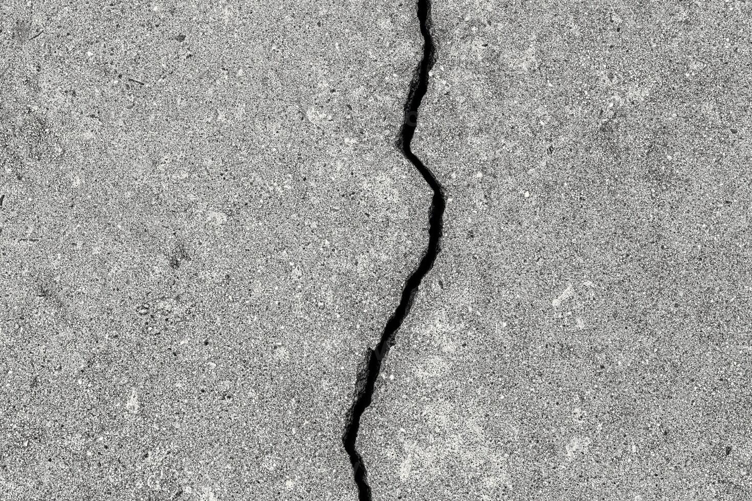 Cracked texture of gray concrete. Abstract background. photo