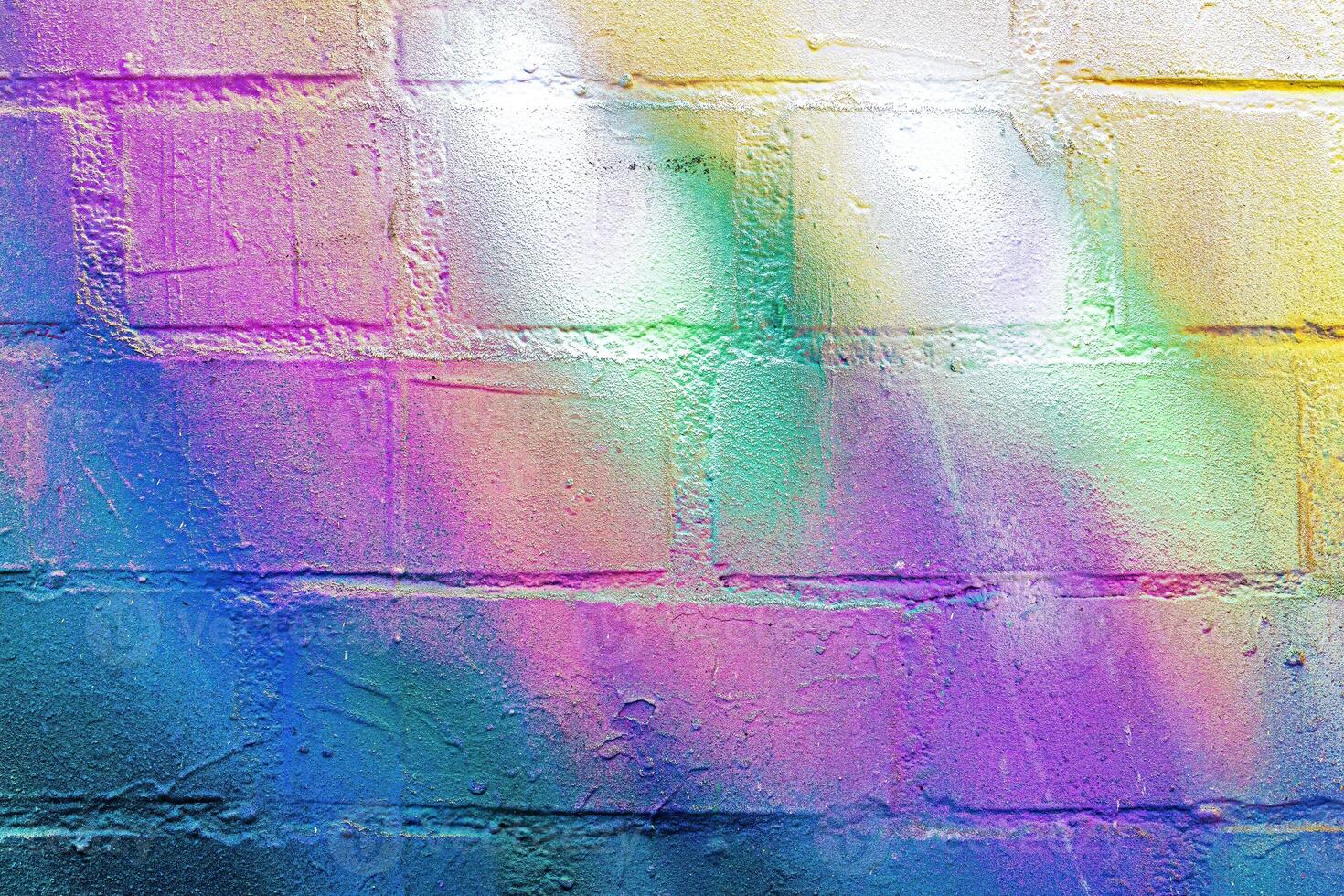 A fragment of colorful graffiti painted on a wall. Abstract urban background. photo