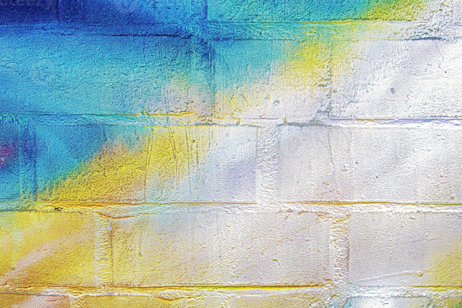A fragment of colorful graffiti painted on a wall. Abstract urban background. photo