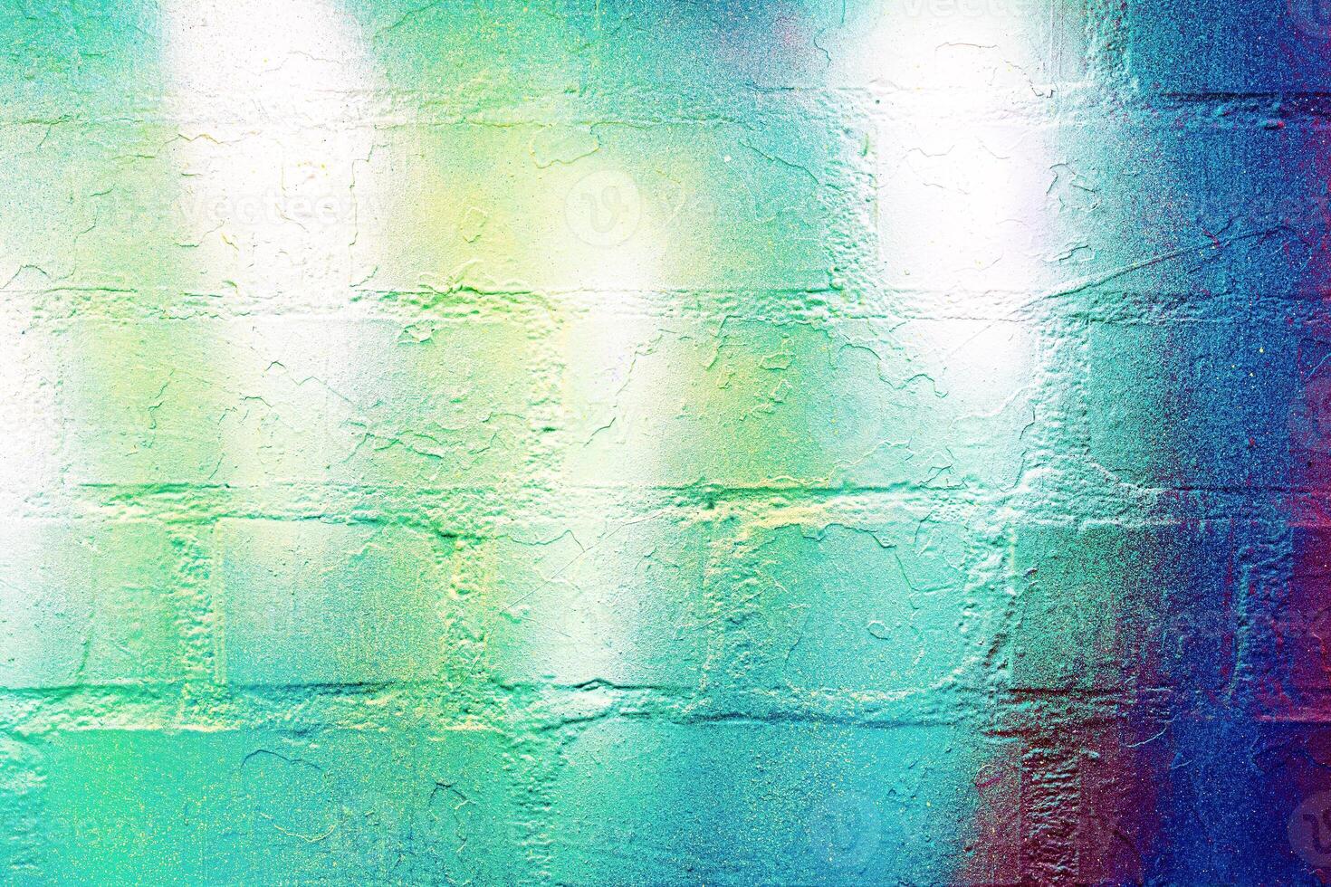 A fragment of colorful graffiti painted on a wall. Abstract urban background. photo