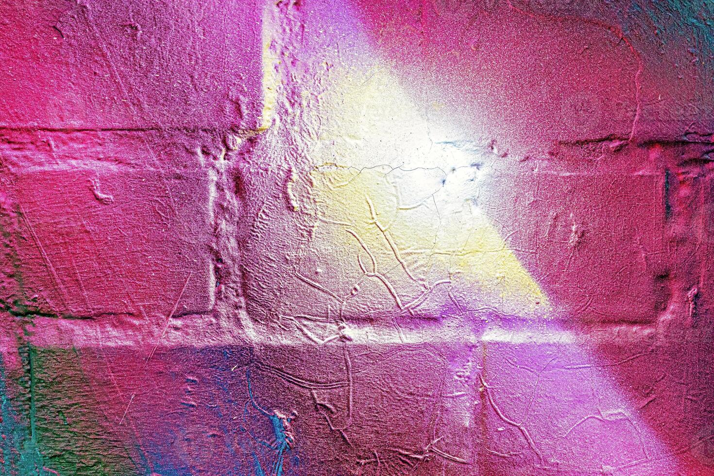 A fragment of colorful graffiti painted on a wall. Abstract urban background. photo