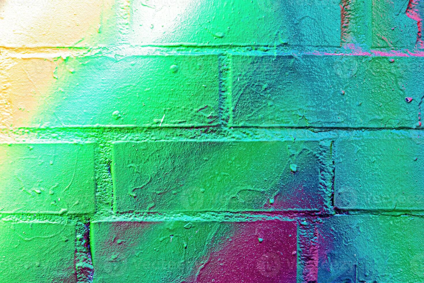 A fragment of colorful graffiti painted on a wall. Abstract urban background. photo