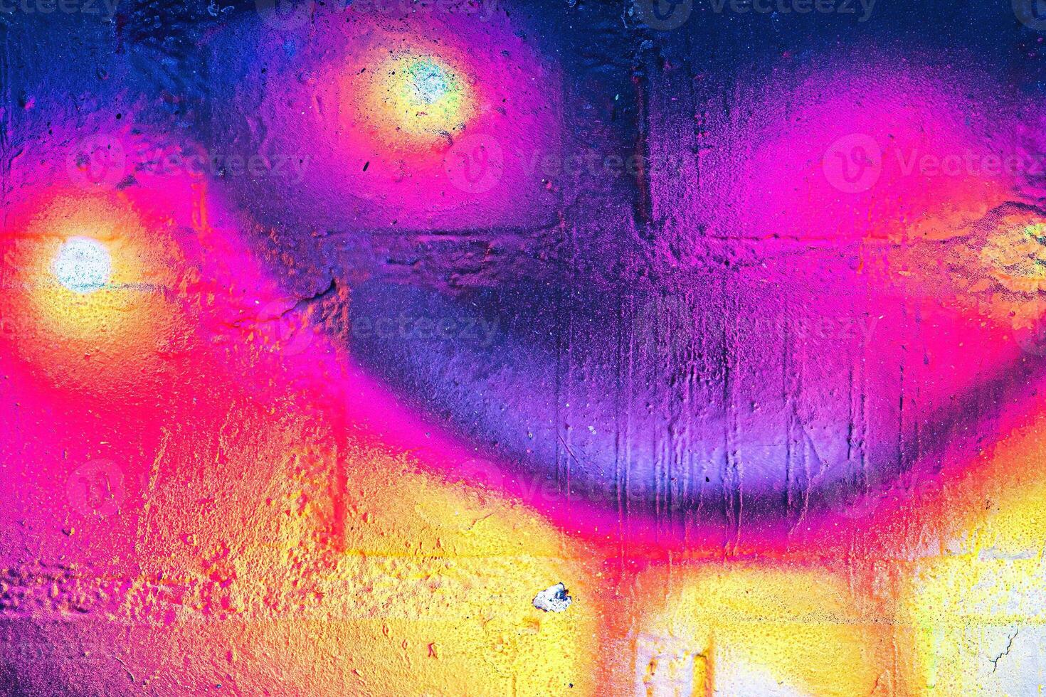 A fragment of colorful graffiti painted on a wall. Abstract urban background. photo