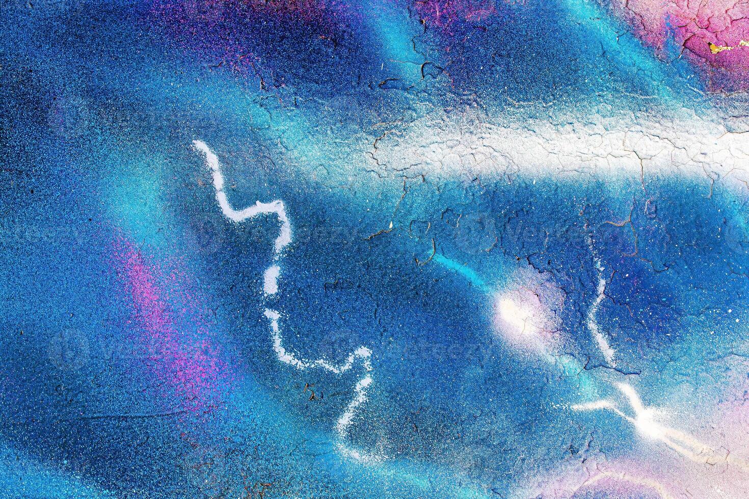 A fragment of colorful graffiti painted on a wall. Abstract urban background. photo