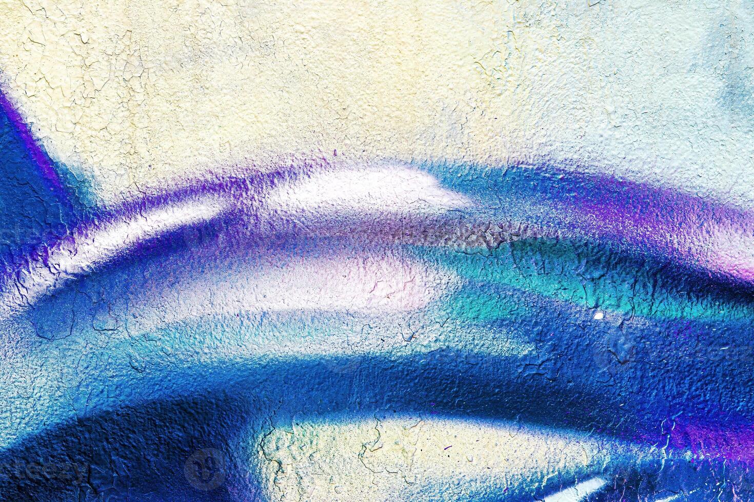 A fragment of colorful graffiti painted on a wall. Abstract urban background. photo