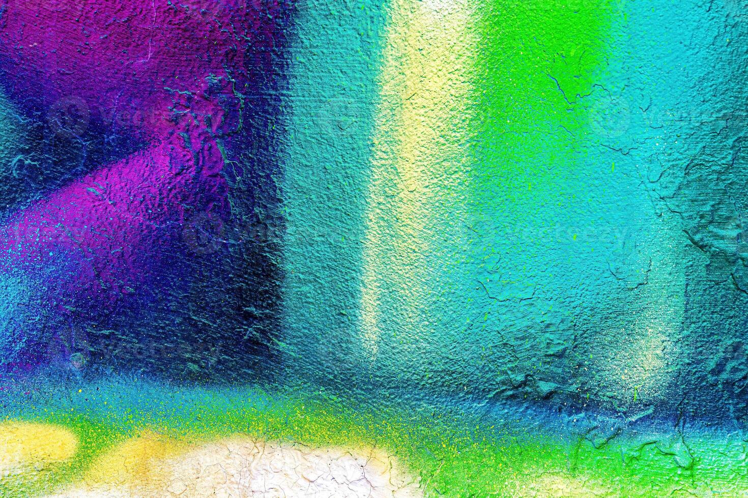 A fragment of colorful graffiti painted on a wall. Abstract urban background. photo