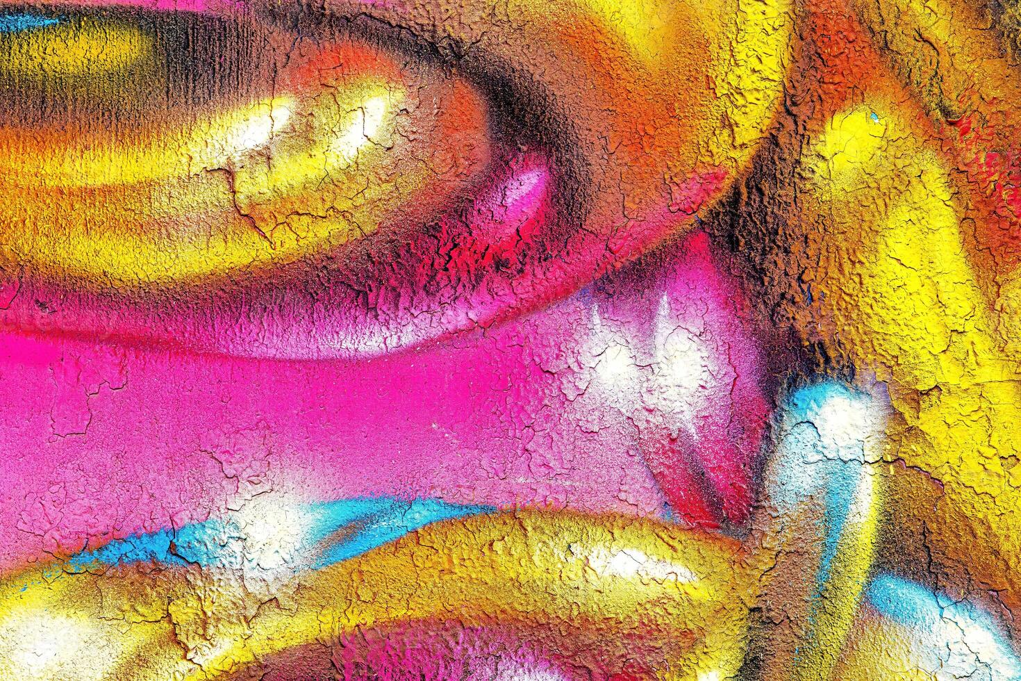 A fragment of colorful graffiti painted on a wall. Abstract urban background. photo
