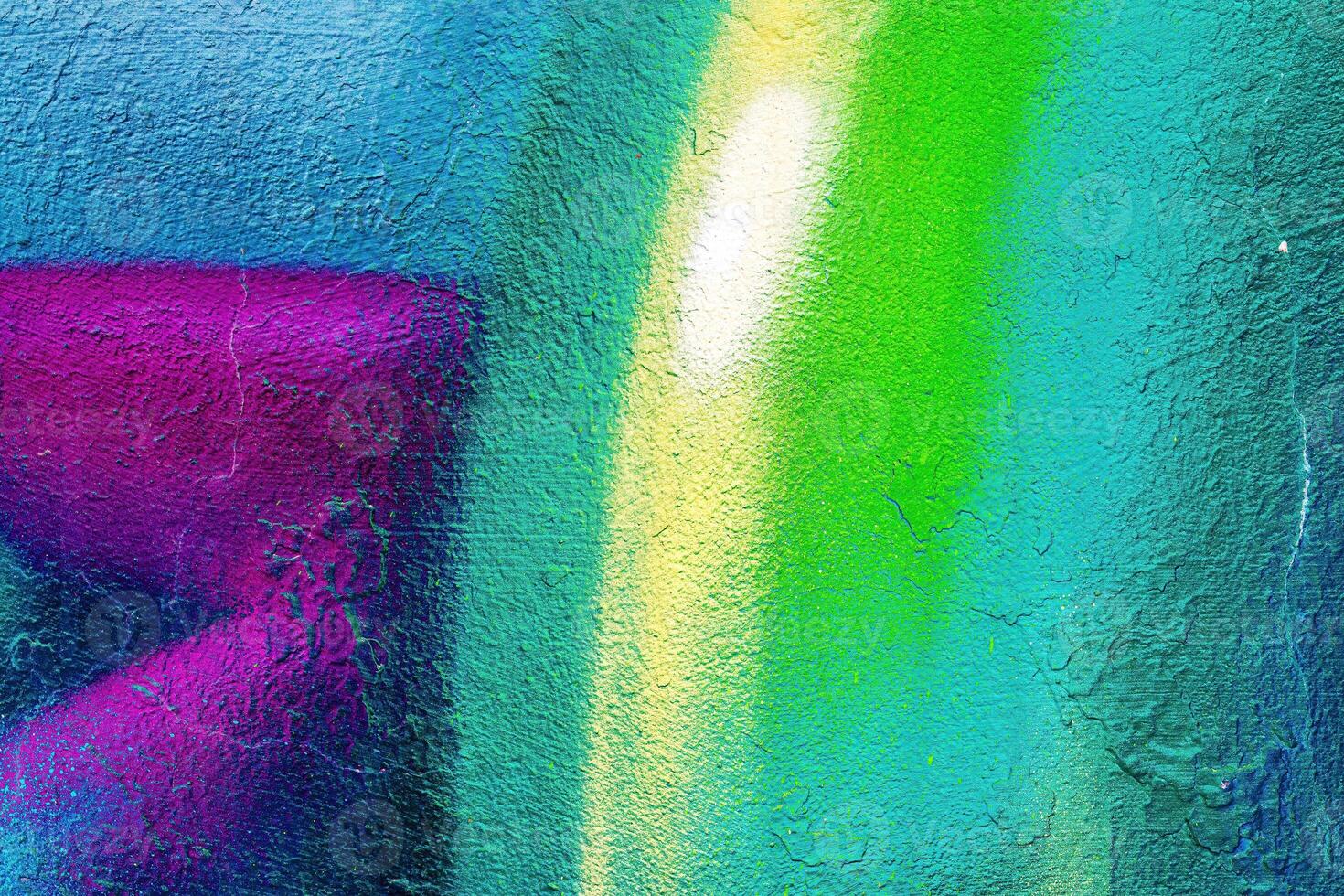 A fragment of colorful graffiti painted on a wall. Abstract urban background. photo