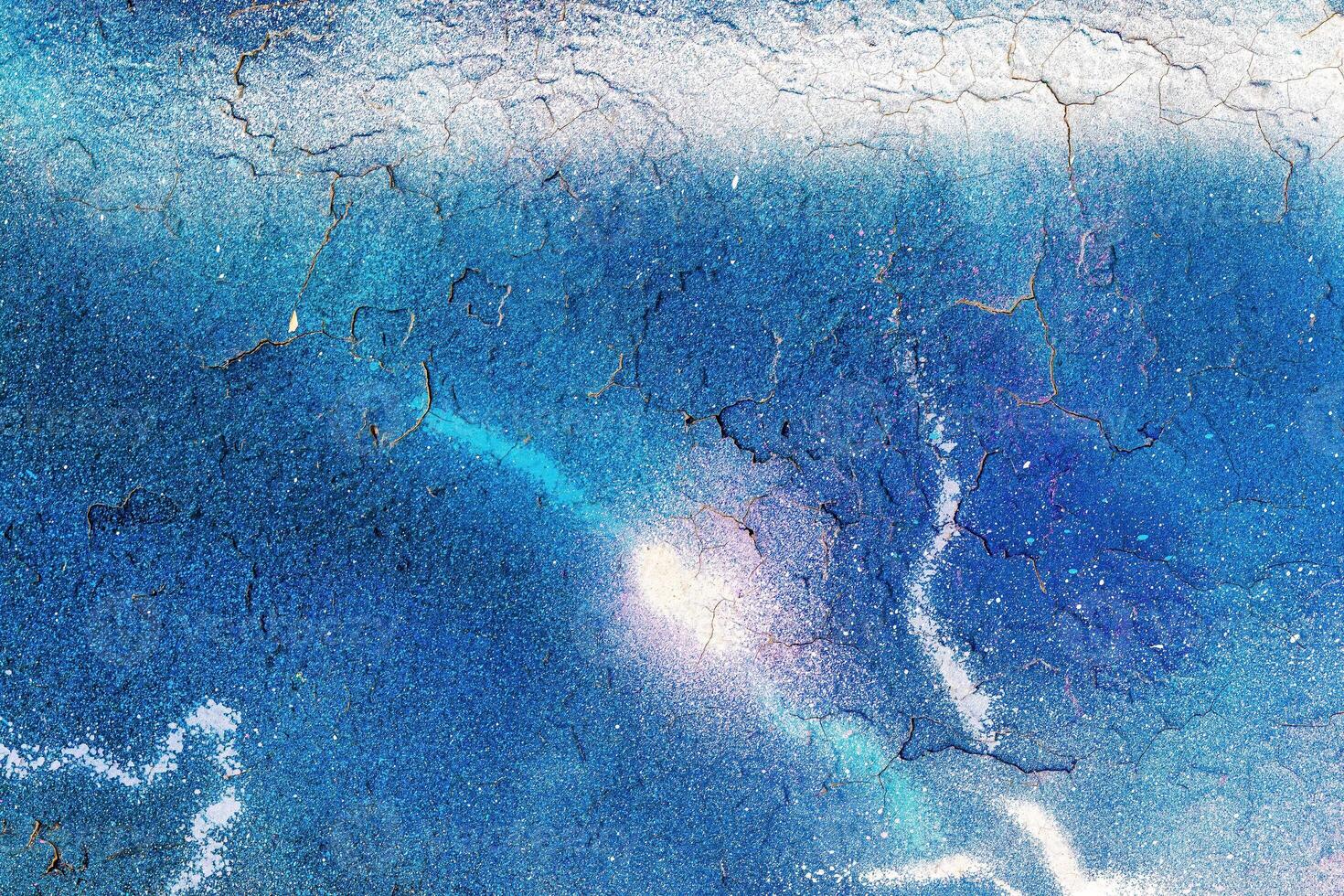 A fragment of colorful graffiti painted on a wall. Abstract urban background. photo