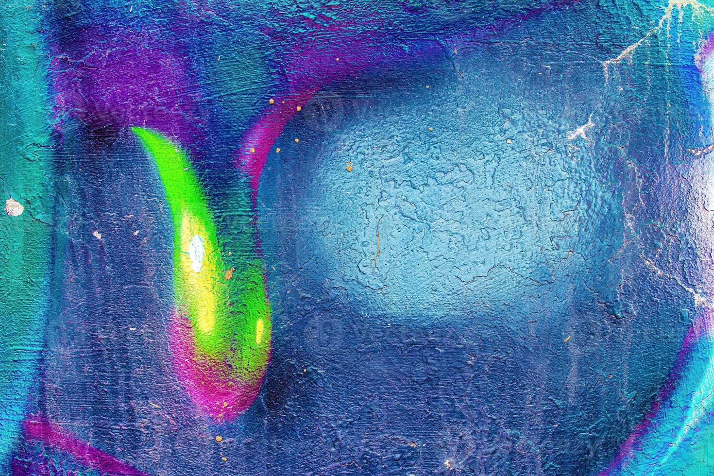 A fragment of colorful graffiti painted on a wall. Abstract urban background. photo