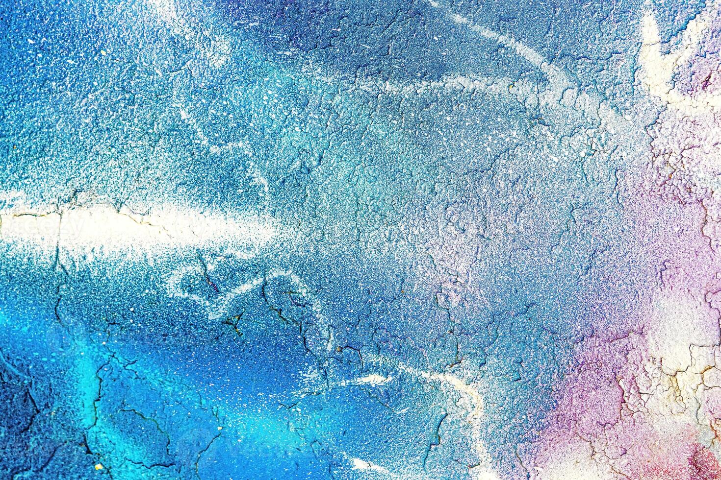 A fragment of colorful graffiti painted on a wall. Abstract urban background. photo