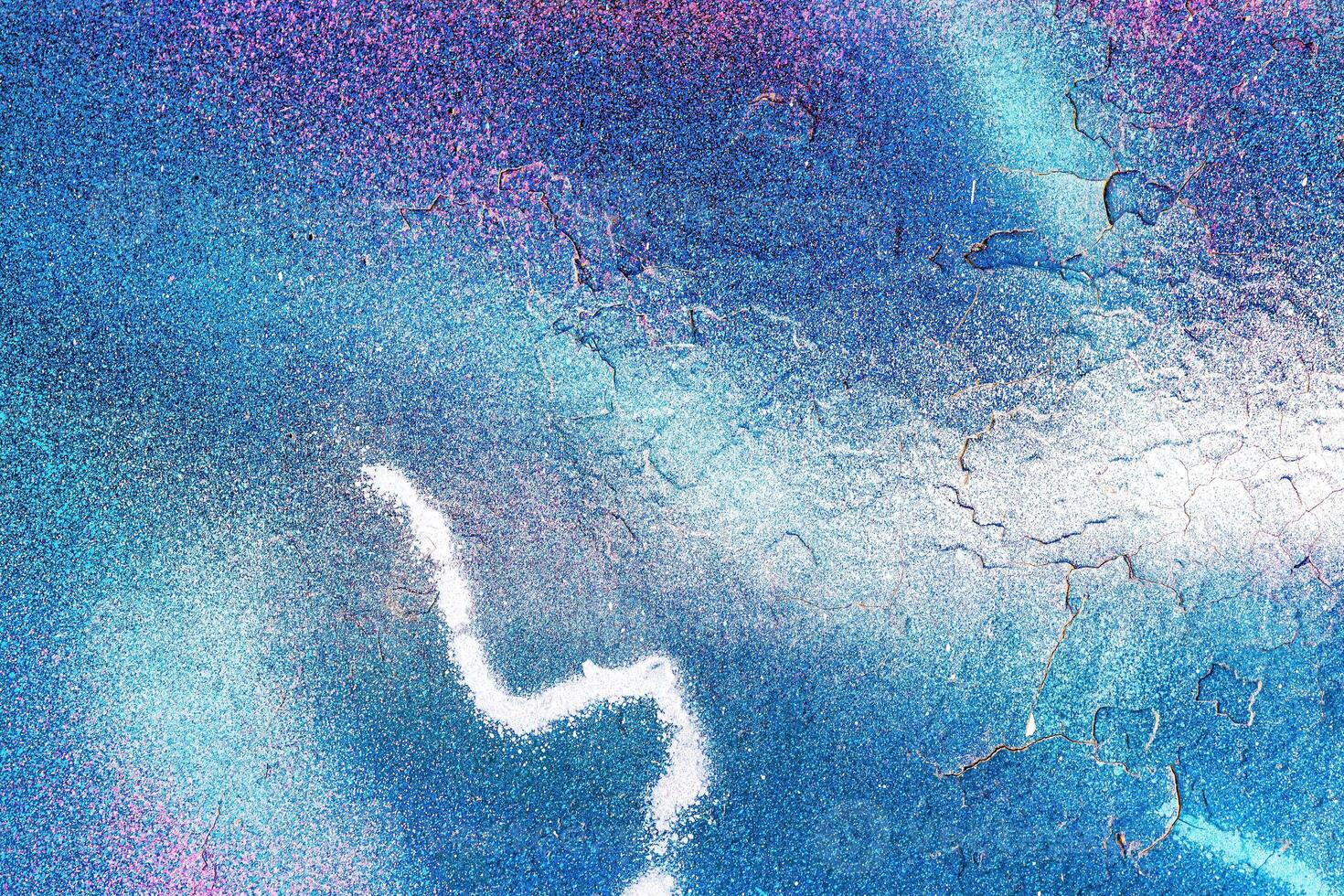 A fragment of colorful graffiti painted on a wall. Abstract urban background. photo