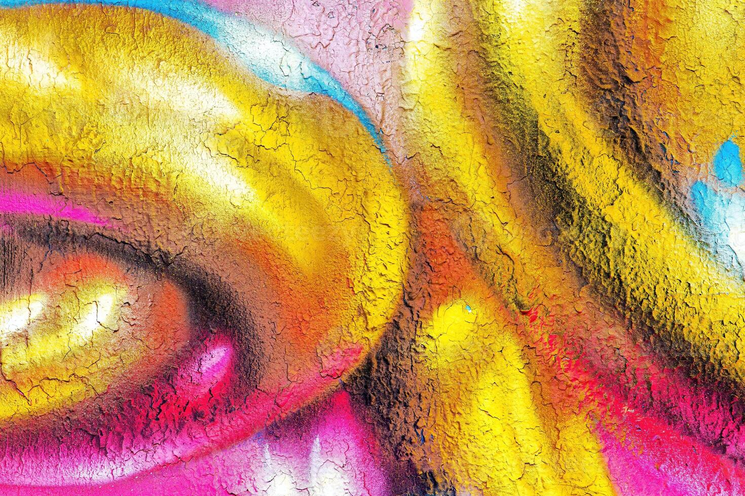 A fragment of colorful graffiti painted on a wall. Abstract urban background. photo