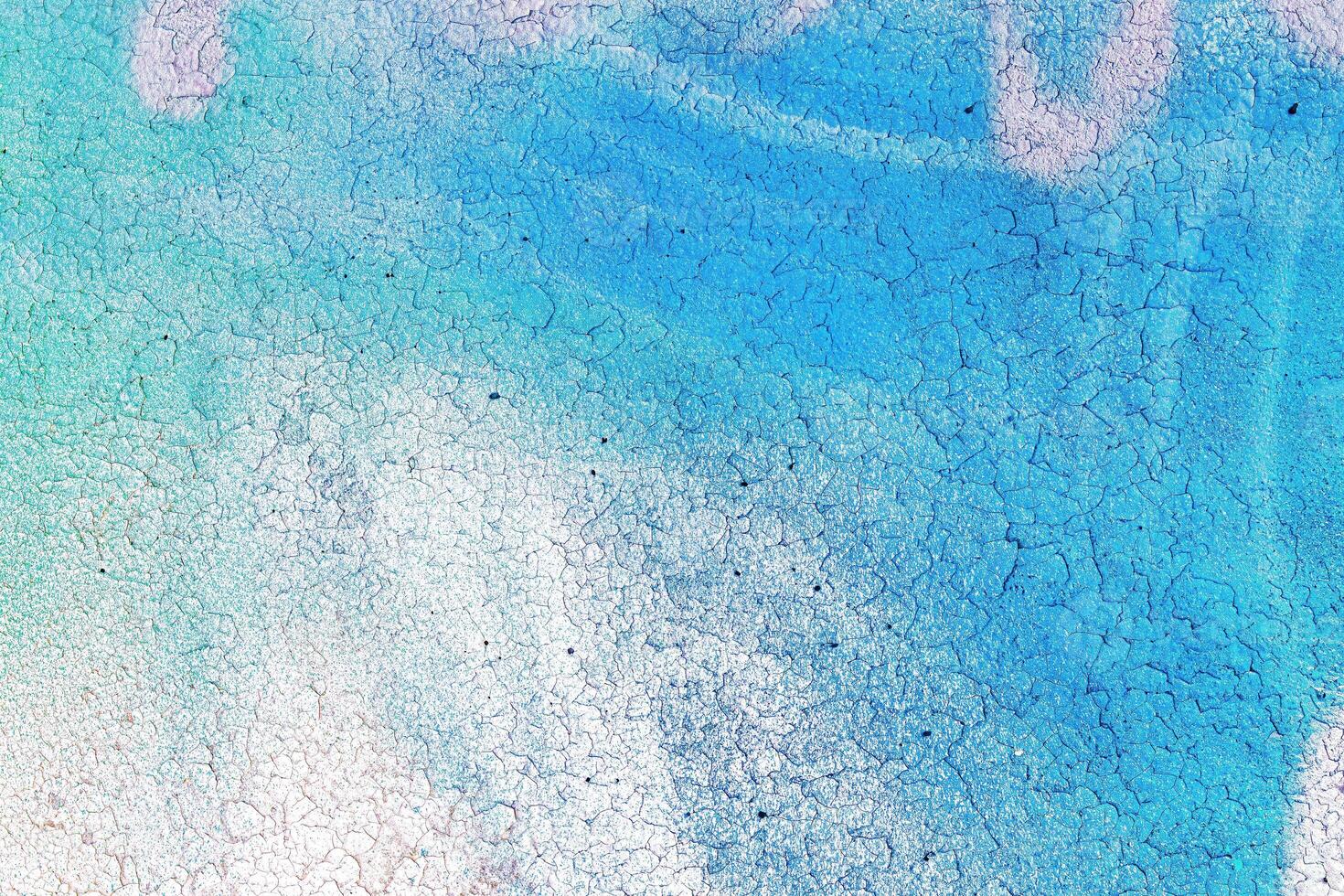 A fragment of colorful graffiti painted on a wall. Abstract urban background. photo