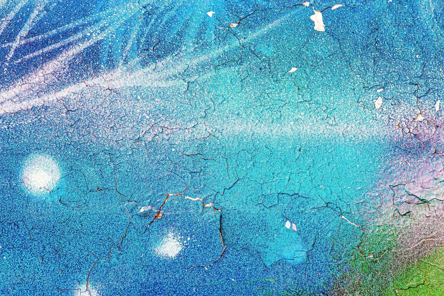 A fragment of colorful graffiti painted on a wall. Abstract urban background. photo