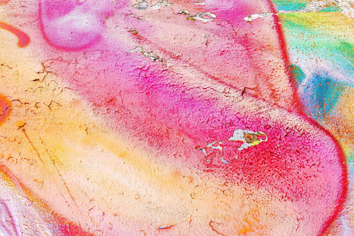 A fragment of colorful graffiti painted on a wall. Abstract urban background. photo