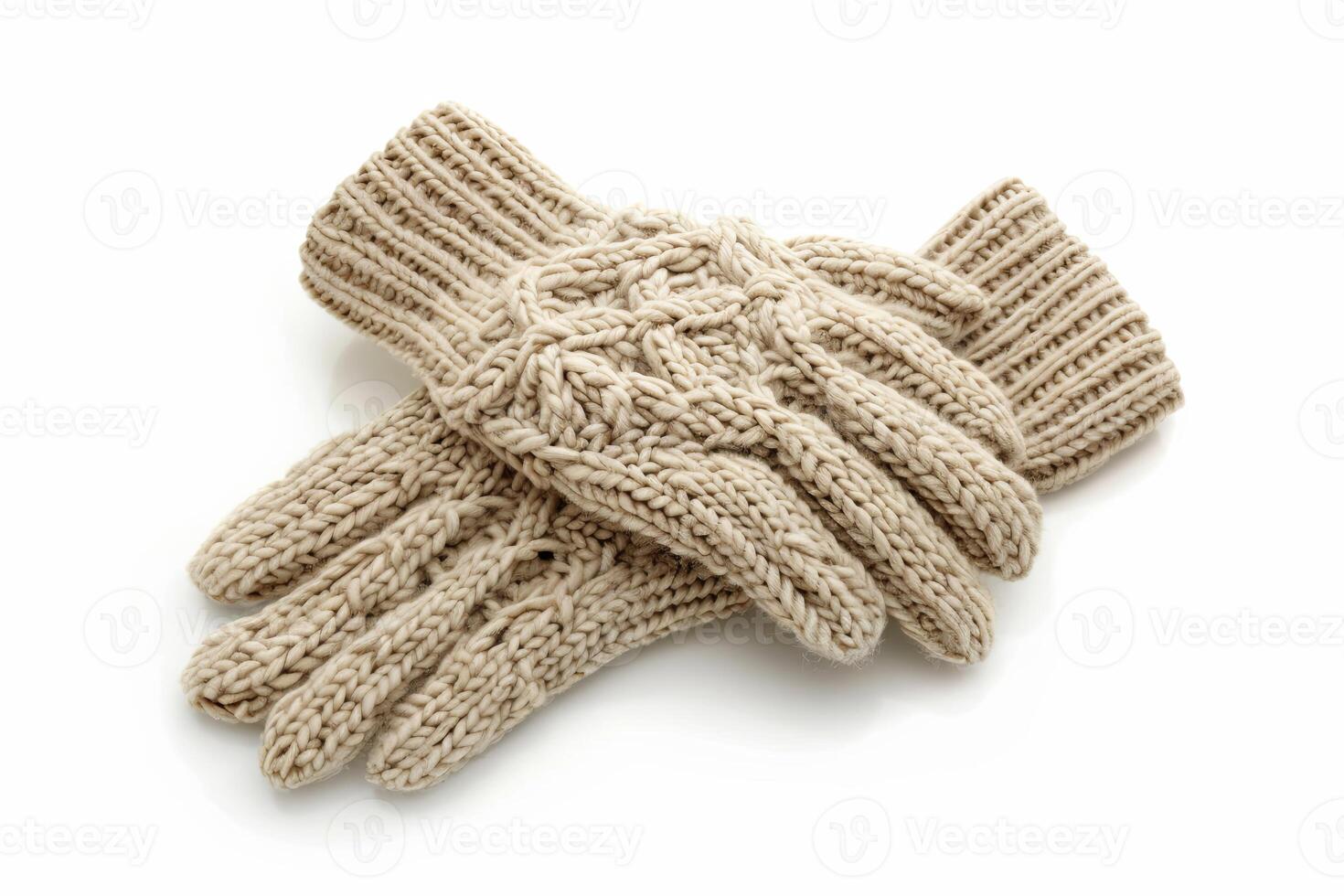 Warm beige knit gloves with patterns on white backdrop. Cozy winter handwear photo