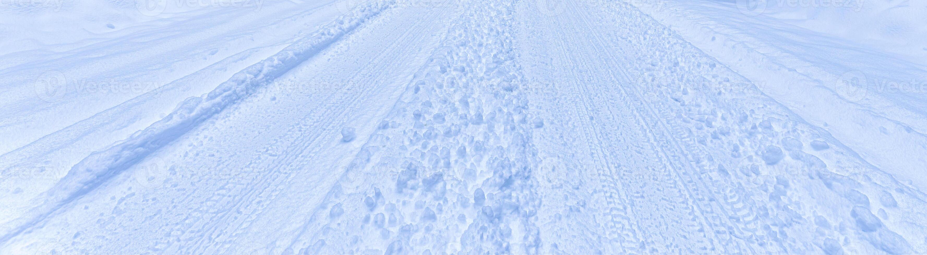 Texture of a snowy road with traces of car tires. photo