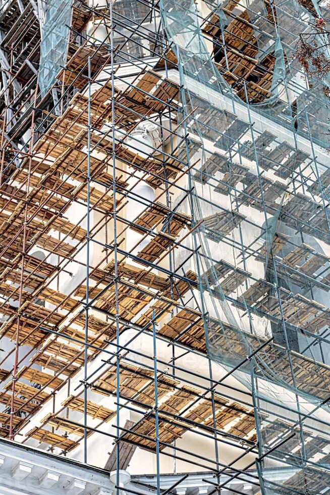 Scaffolding without people on the reconstruction of a historic building. photo