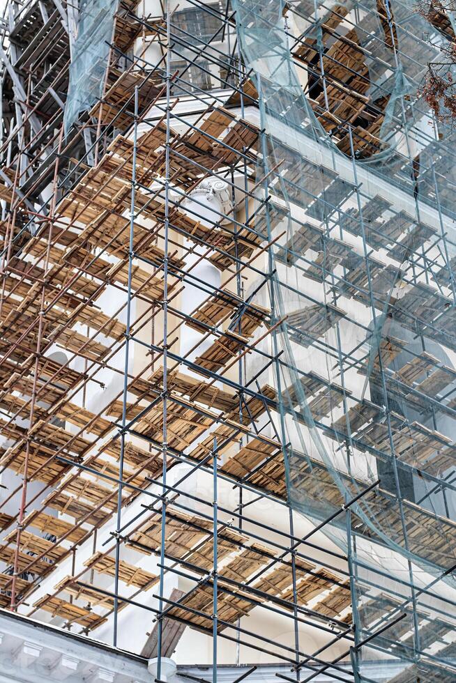 Scaffolding without people on the reconstruction of a historic building. photo