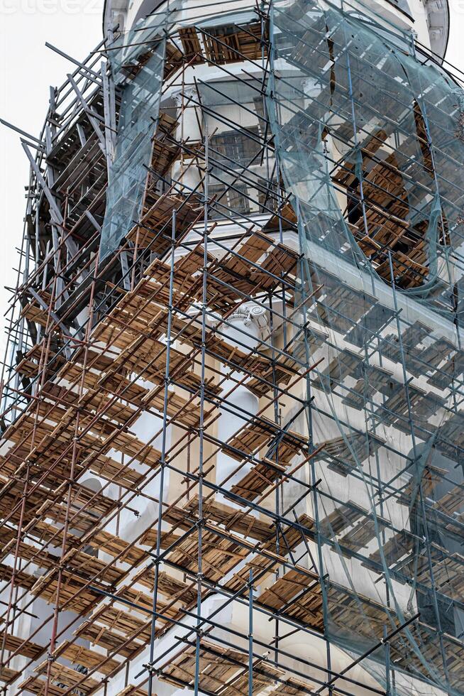 Scaffolding without people on the reconstruction of a historic building. photo