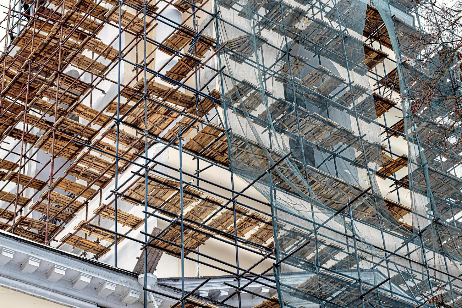 Scaffolding without people on the reconstruction of a historic building. photo