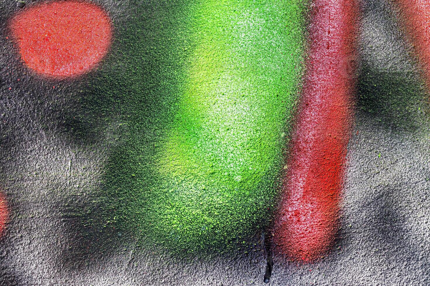 A fragment of colorful graffiti painted on a wall. Abstract urban background. photo