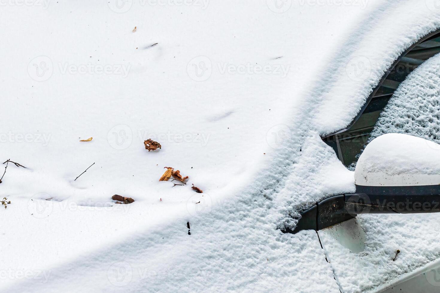Frozen car windshield covered and rearview mirror with ice and snow on a winter day. photo