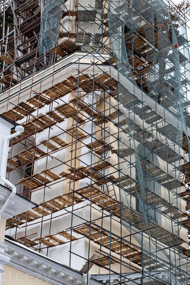 Scaffolding without people on the reconstruction of a historic building. photo