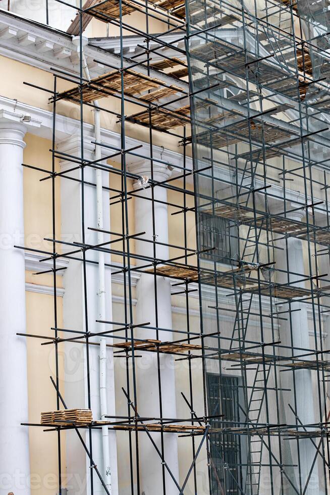 Scaffolding without people on the reconstruction of a historic building. photo