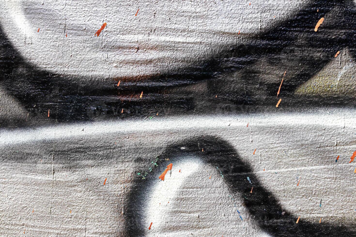A fragment of colorful graffiti painted on a wall. Abstract urban background. photo