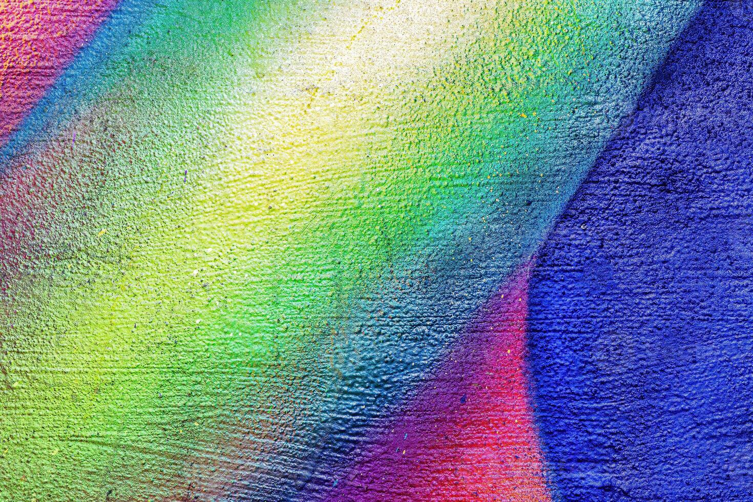 A fragment of colorful graffiti painted on a wall. Abstract urban background. photo