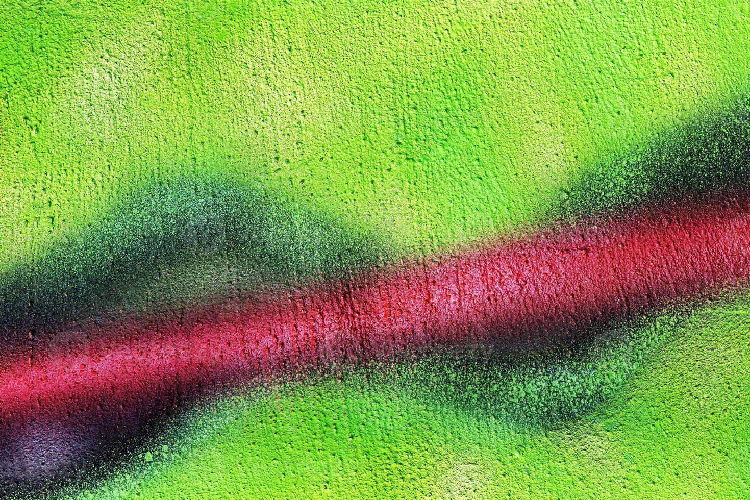 A fragment of colorful graffiti painted on a wall. Abstract urban background. photo