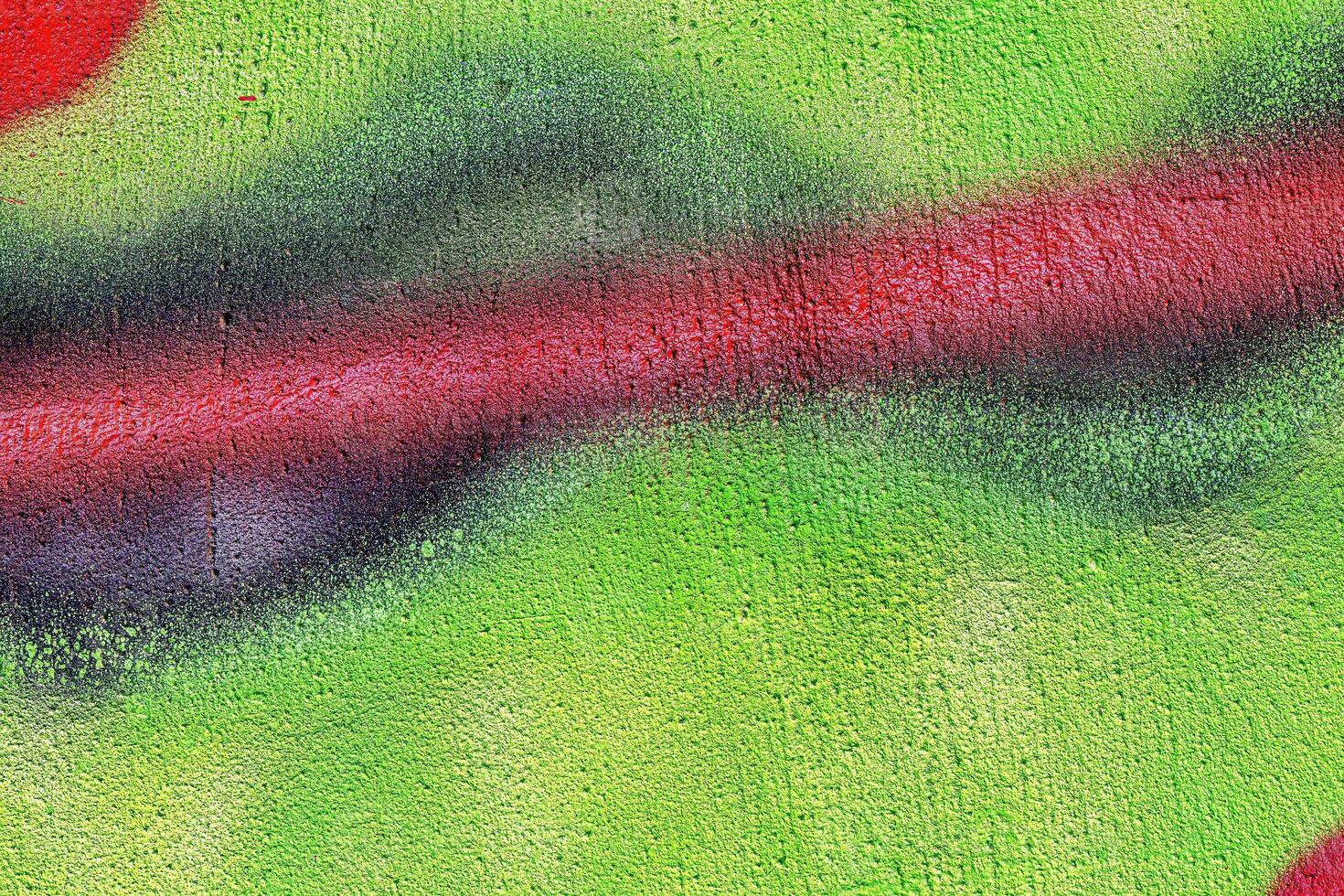 A fragment of colorful graffiti painted on a wall. Abstract urban background. photo