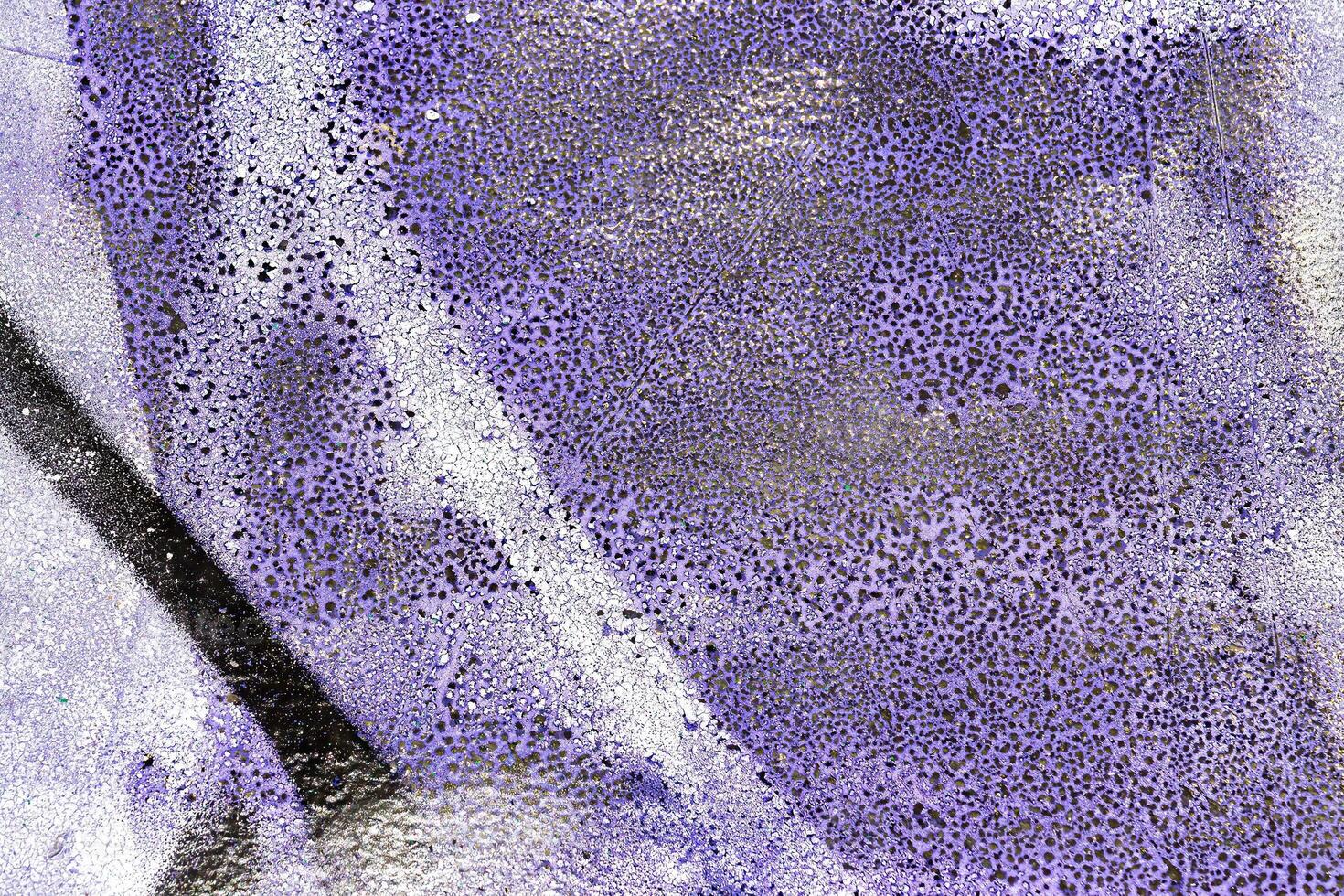 A fragment of colorful graffiti painted on a wall. Abstract urban background. photo