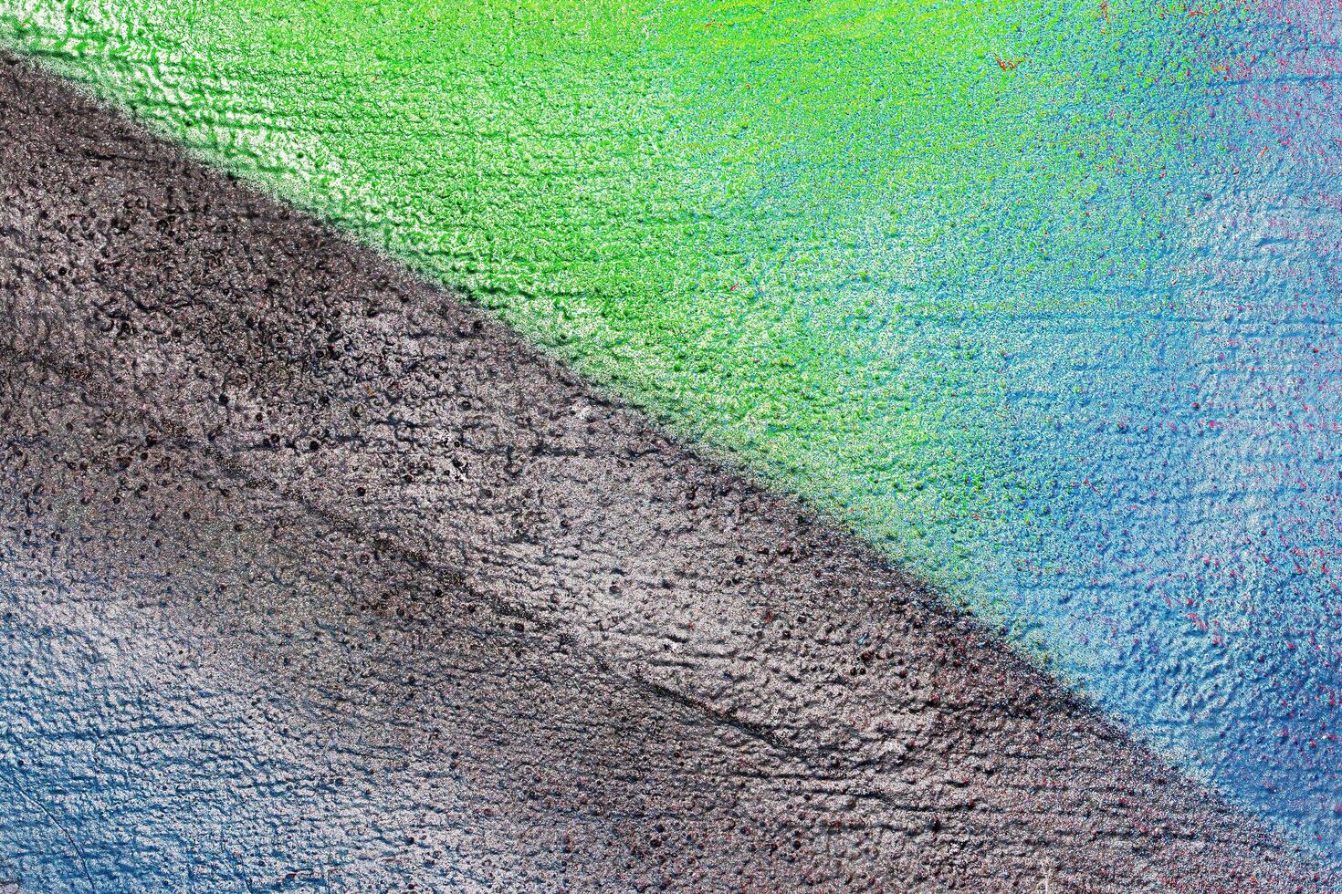 A fragment of colorful graffiti painted on a wall. Abstract urban background. photo