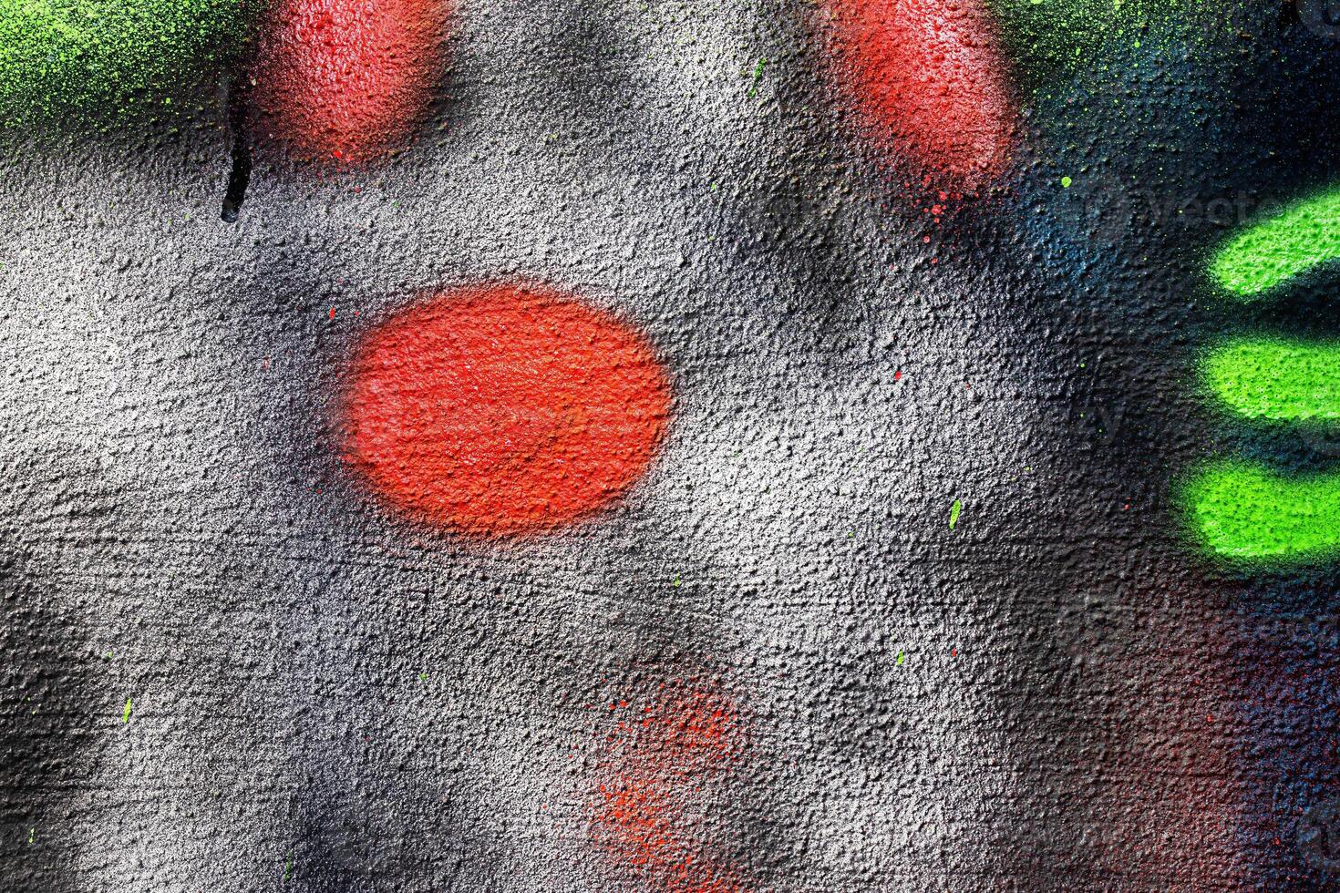 A fragment of colorful graffiti painted on a wall. Abstract urban background. photo