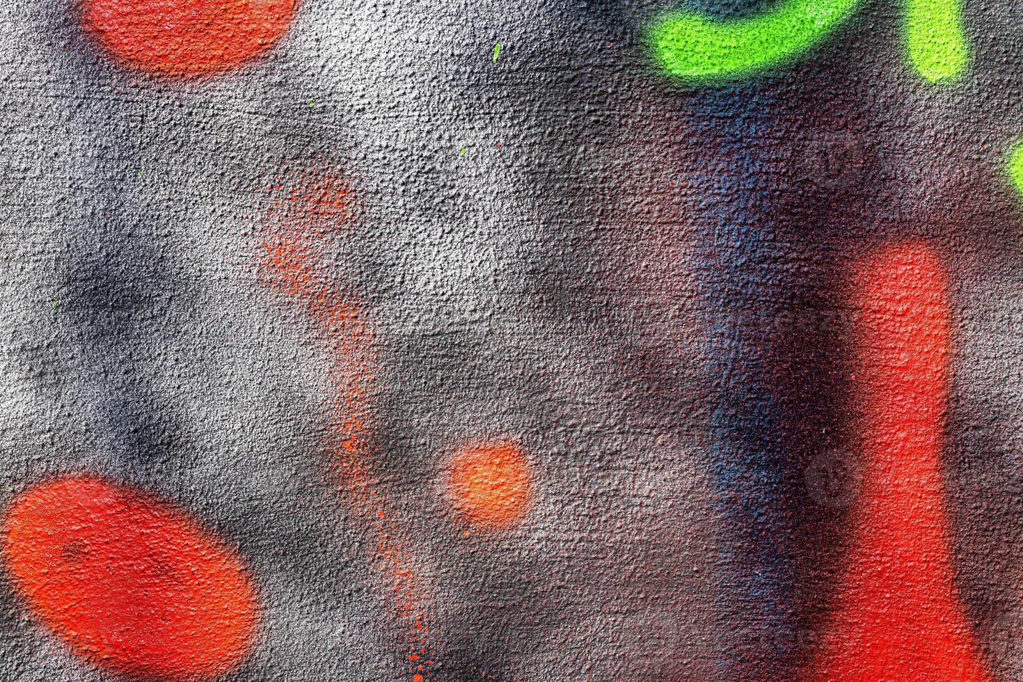 A fragment of colorful graffiti painted on a wall. Abstract urban background. photo