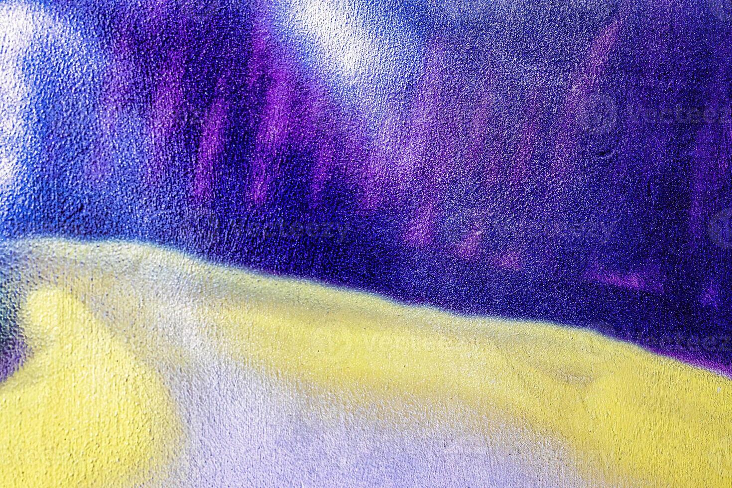 A fragment of colorful graffiti painted on a wall. Abstract urban background. photo