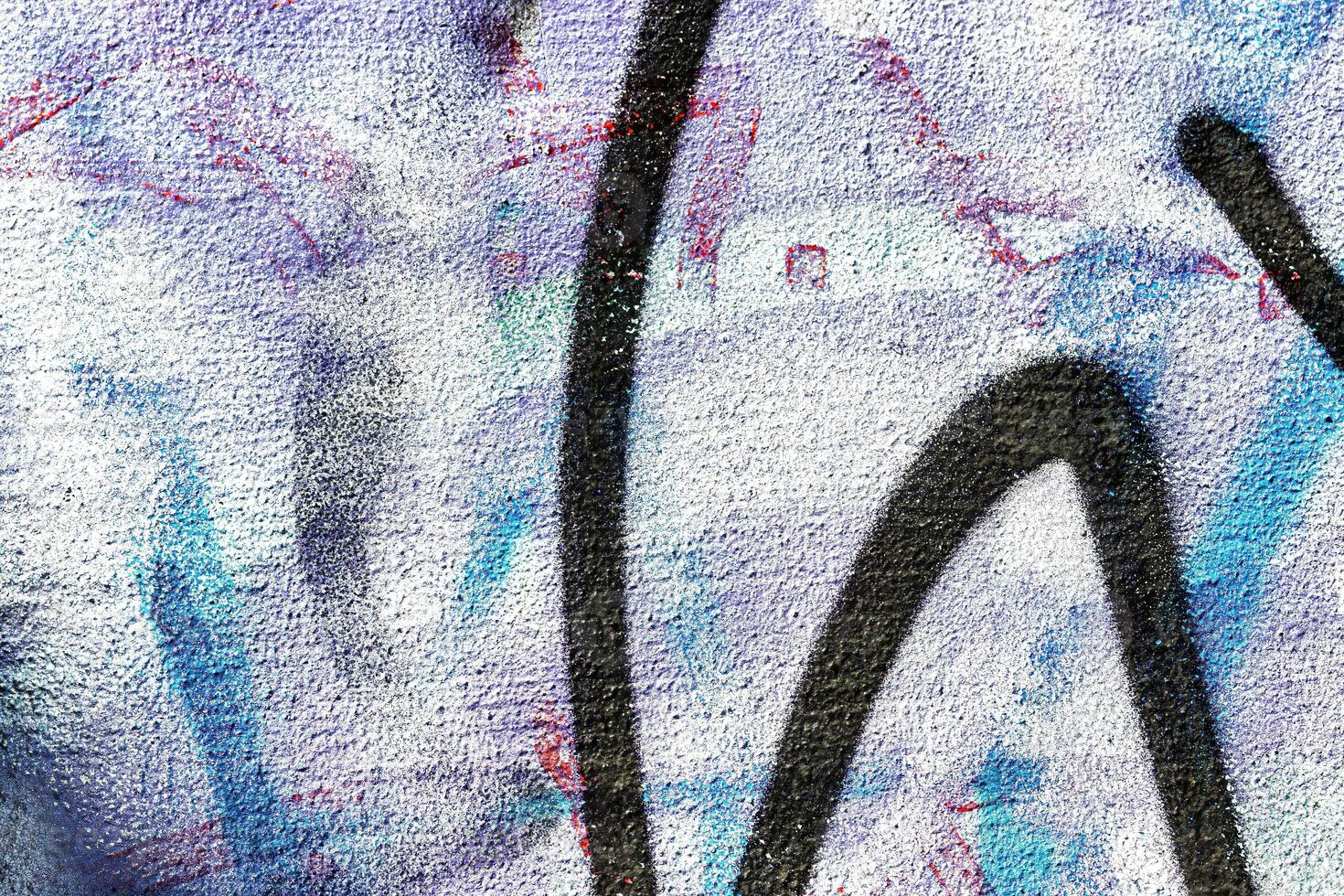 A fragment of colorful graffiti painted on a wall. Abstract urban background. photo