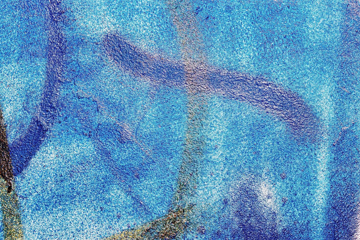 A fragment of colorful graffiti painted on a wall. Abstract urban background. photo