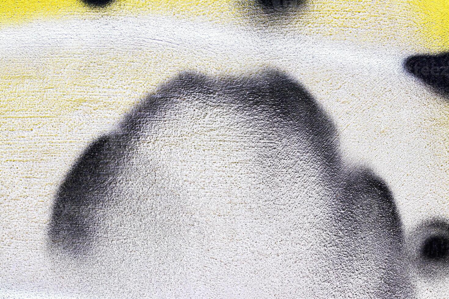 A fragment of colorful graffiti painted on a wall. Abstract urban background. photo