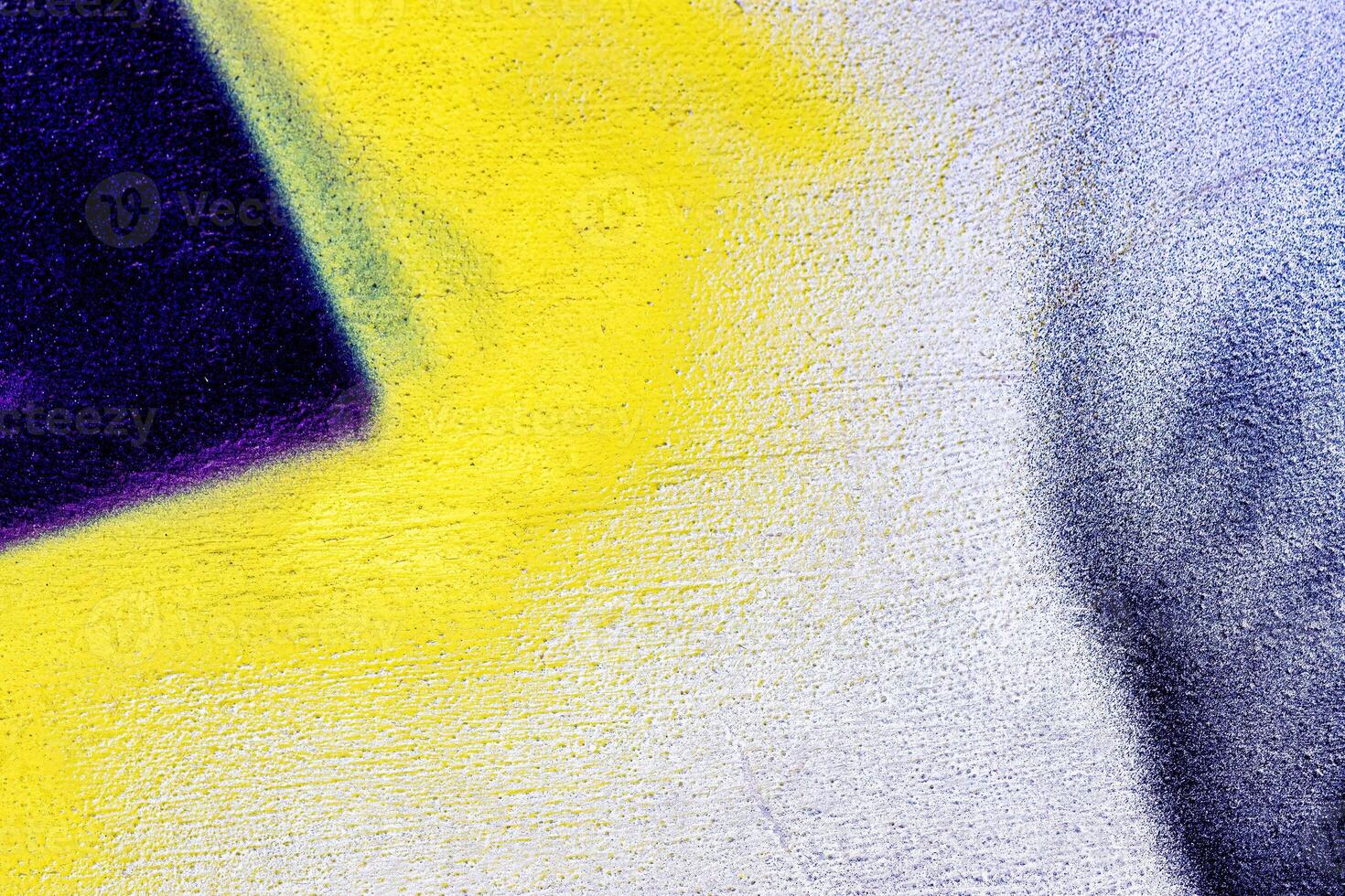 A fragment of colorful graffiti painted on a wall. Abstract urban background. photo