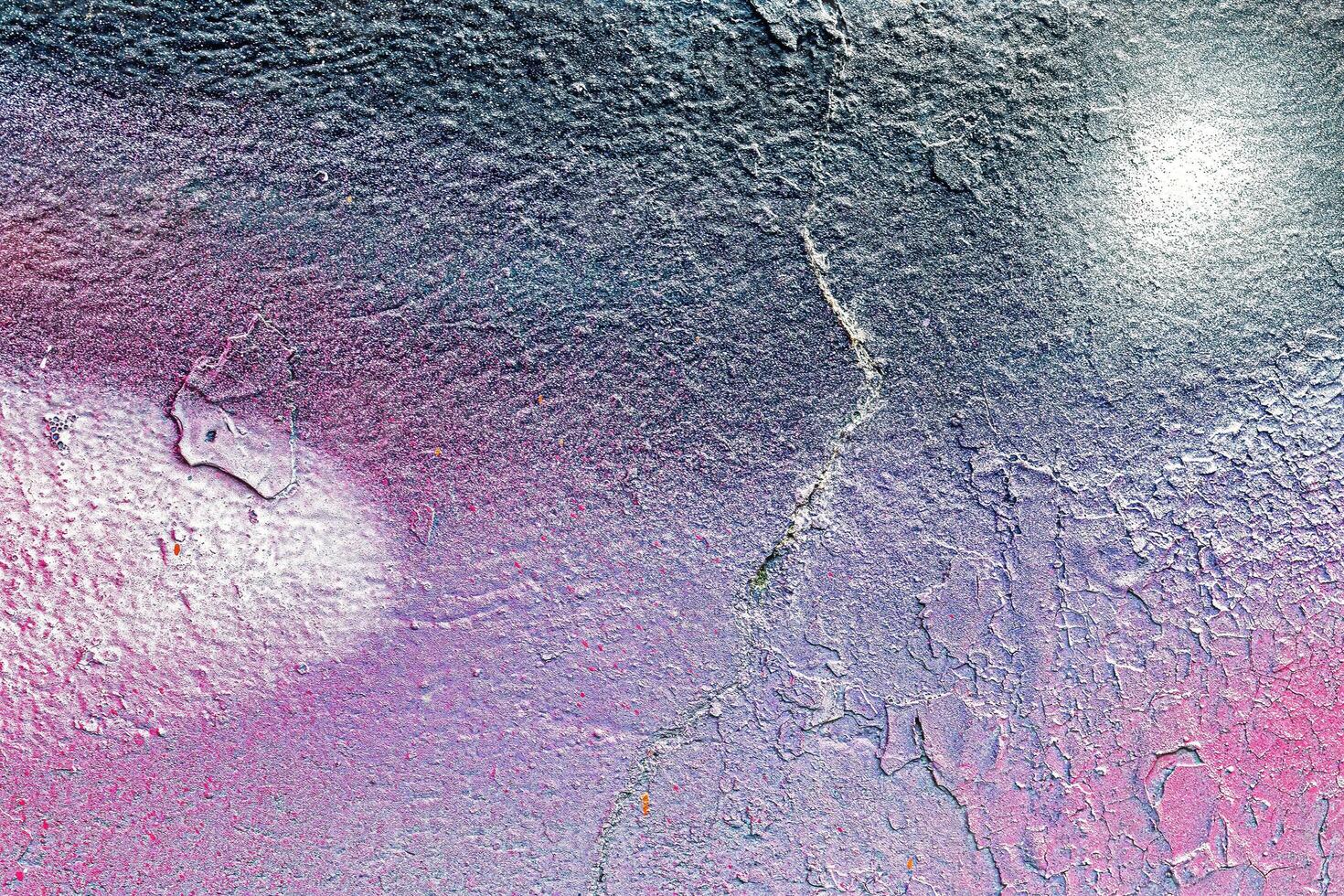 A fragment of colorful graffiti painted on a wall. Abstract urban background. photo