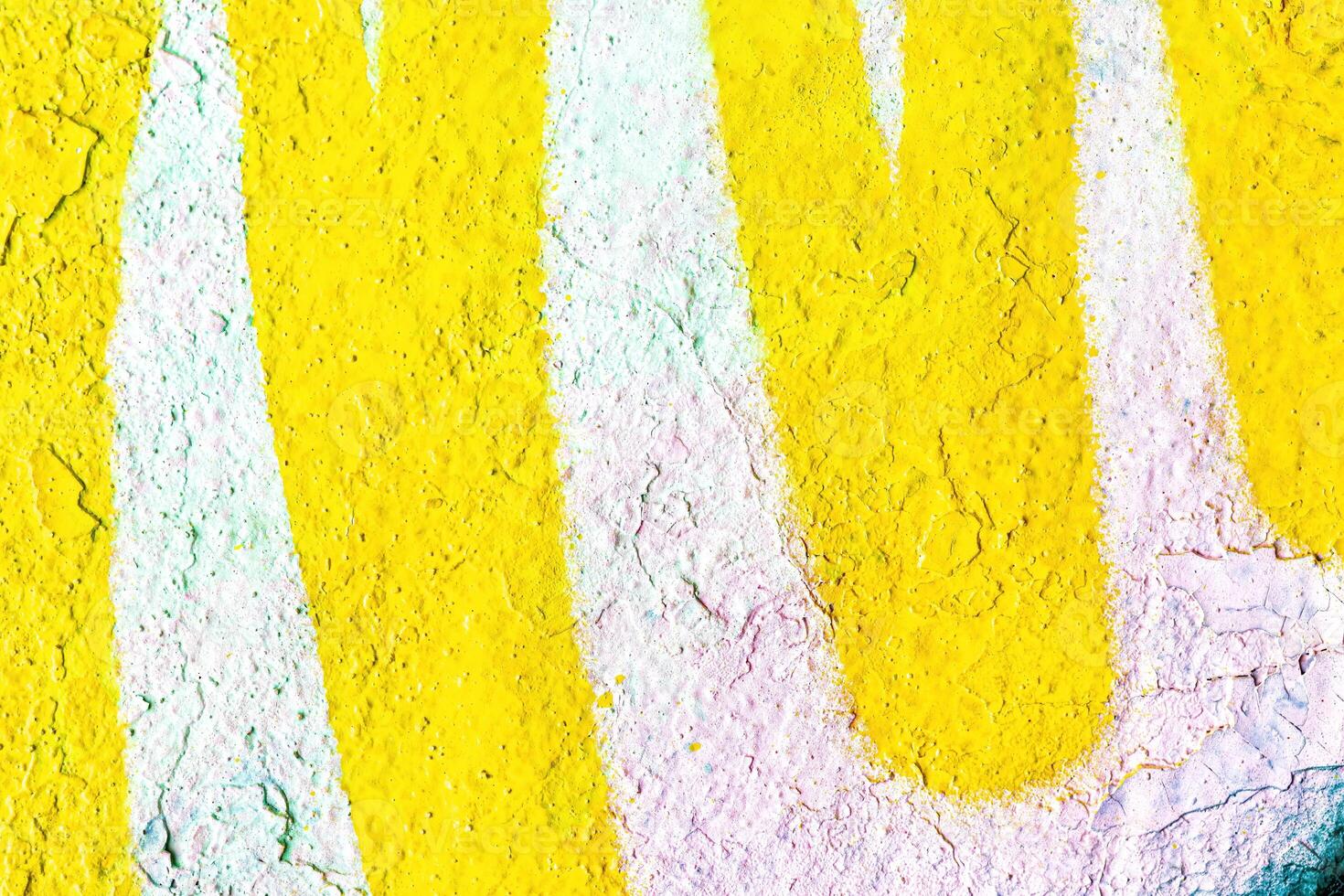 A fragment of colorful graffiti painted on a wall. Abstract urban background. photo