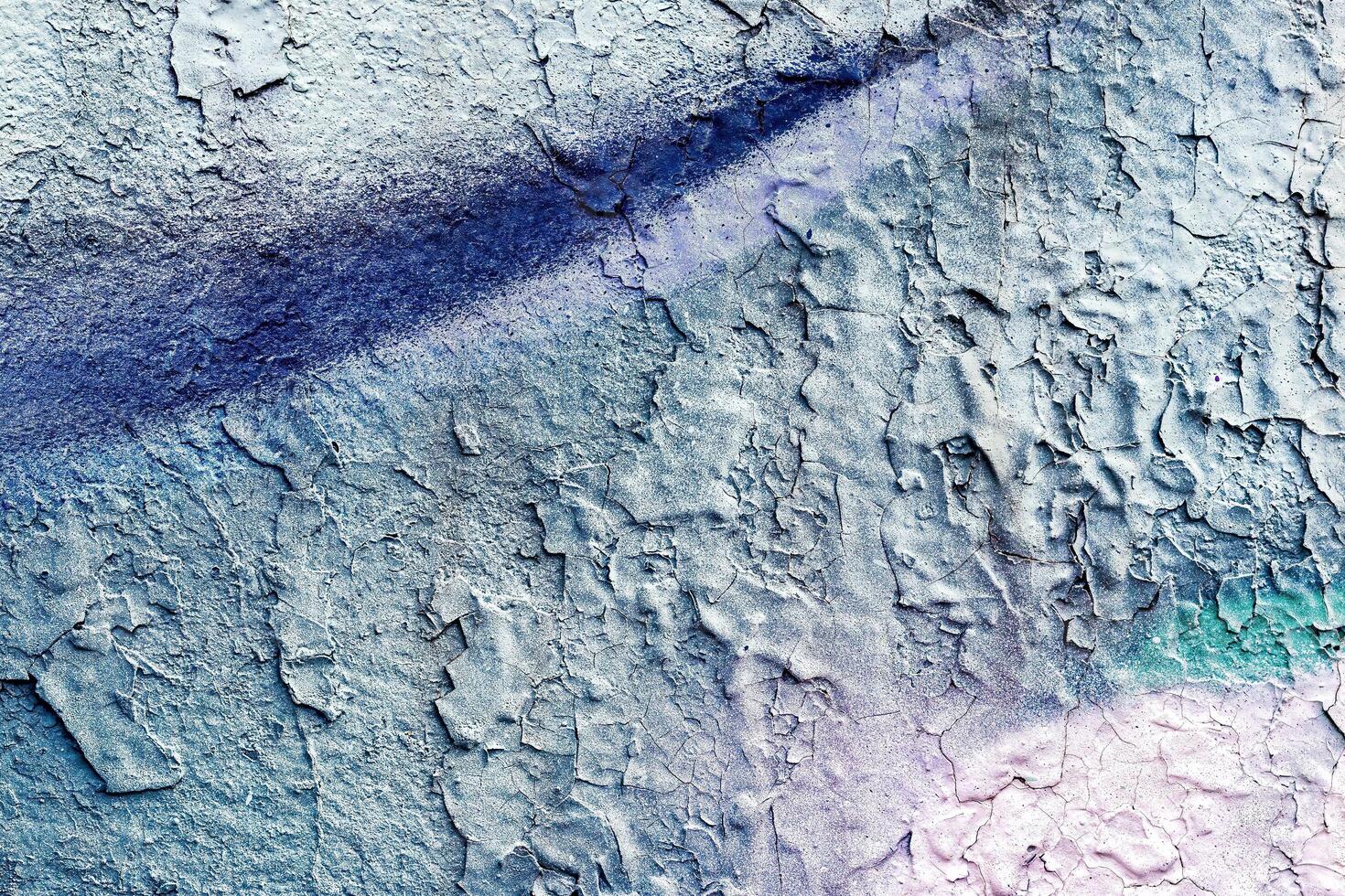A fragment of colorful graffiti painted on a wall. Abstract urban background. photo
