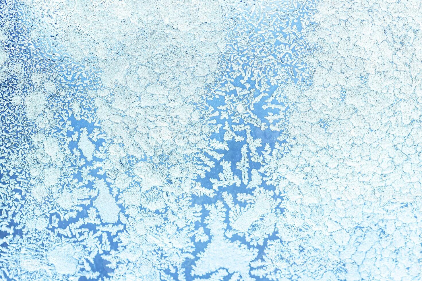 The texture of the glass covered with frost in winter in cold weather. Abstract background. photo