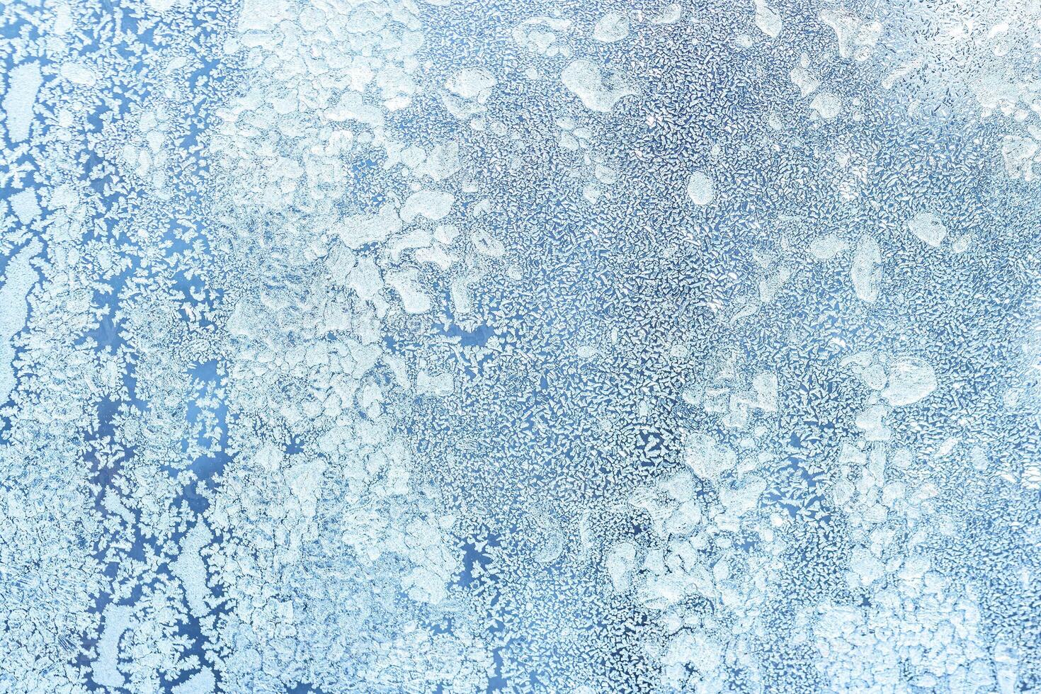 The texture of the glass covered with frost in winter in cold weather. Abstract background. photo