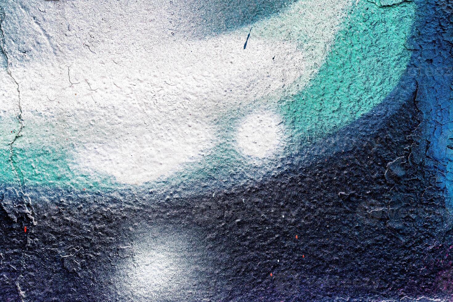A fragment of colorful graffiti painted on a wall. Abstract urban background. photo