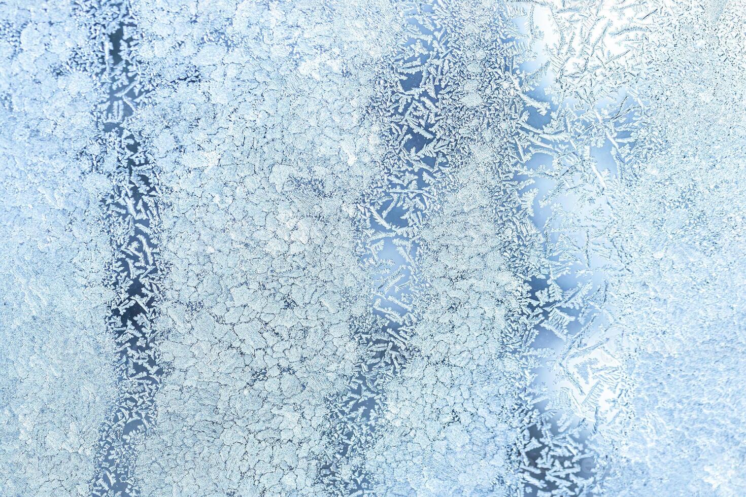 The texture of the glass covered with frost in winter in cold weather. Abstract background. photo